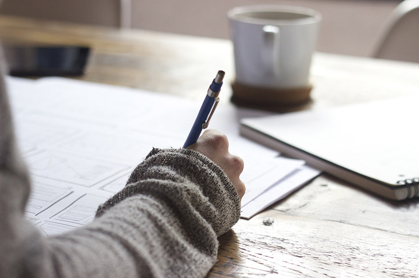 person writing with pen