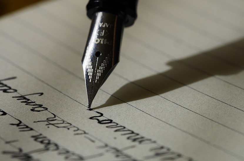 closeup of fountain pen writing on parchment