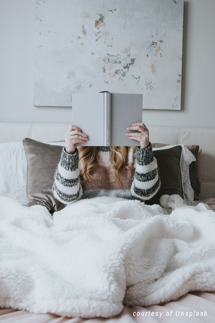 girl reading in bed