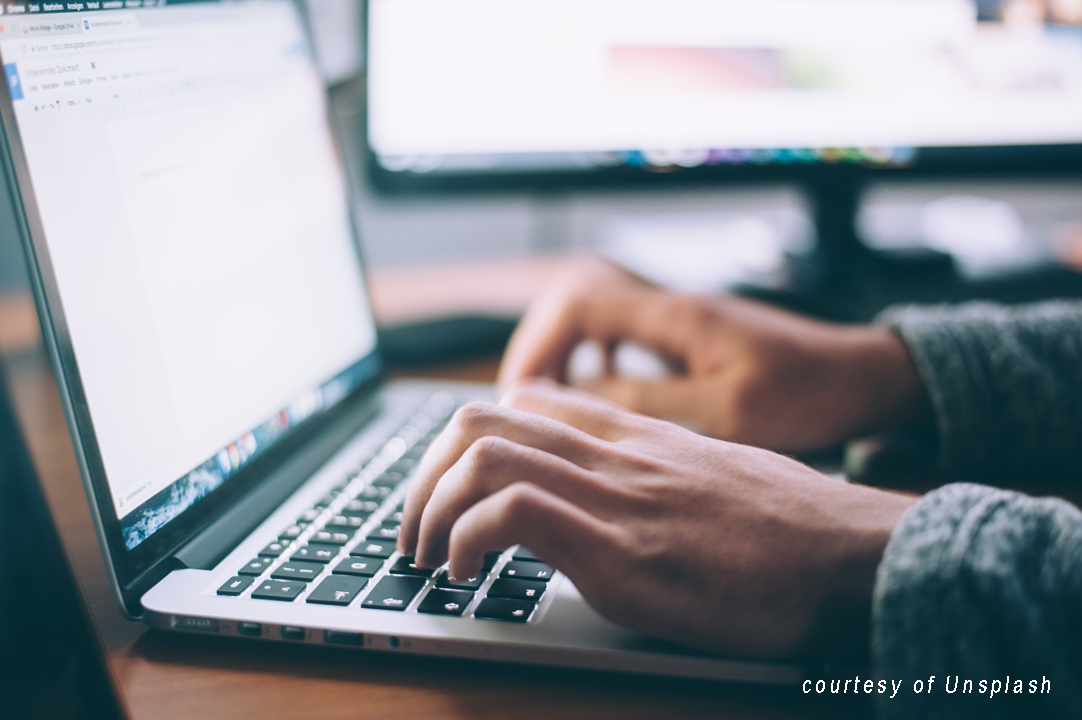 person typing on a laptop