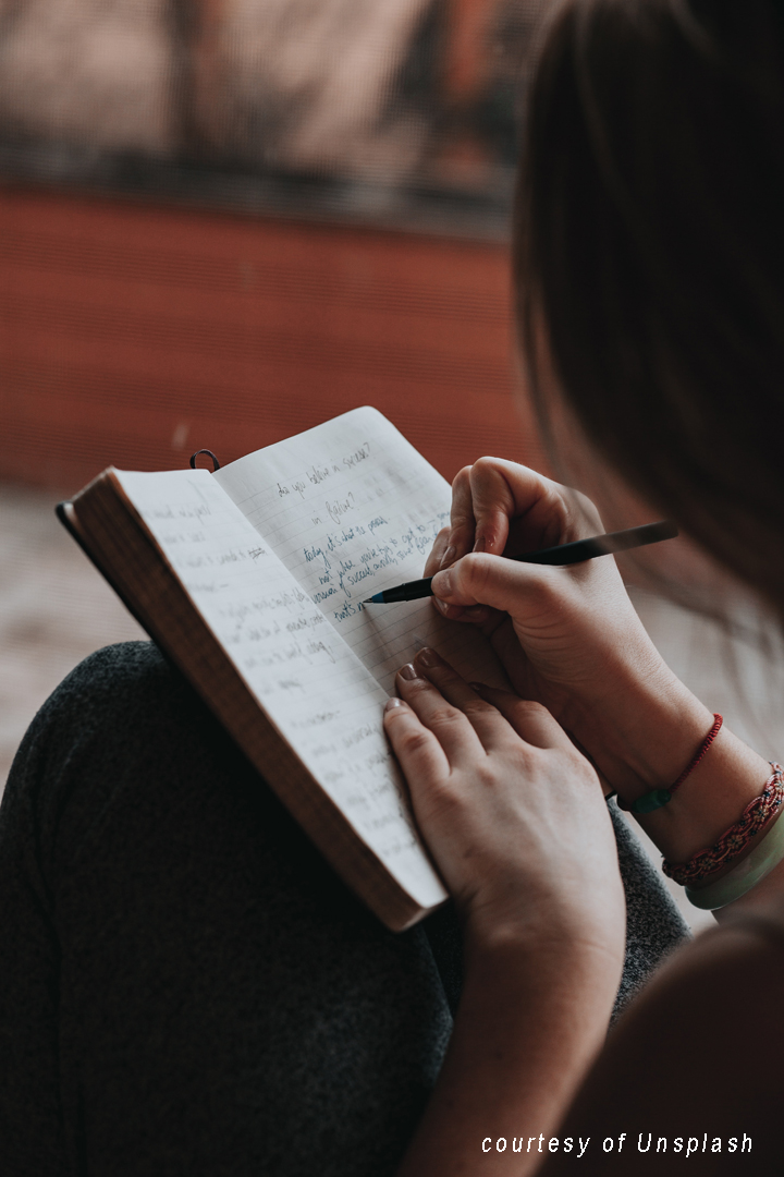 woman writing in a journal